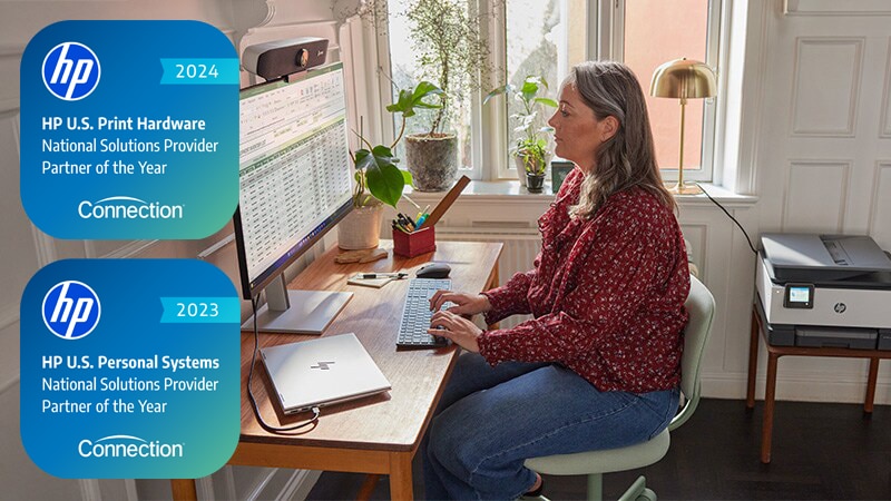 Woman using HP products - laptop, monitor and printer